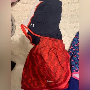 Nike and under armor running shorts. Multi color. Size medium